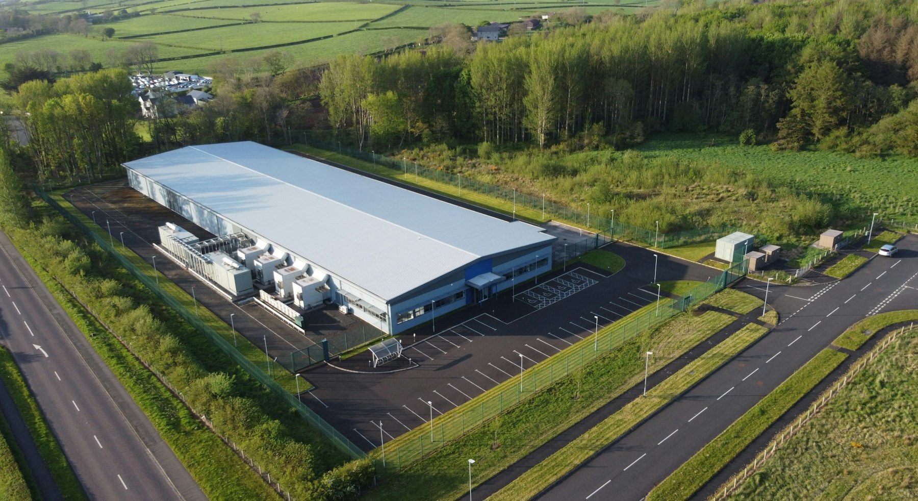 Aerial view of a data center building surrounded by countryside